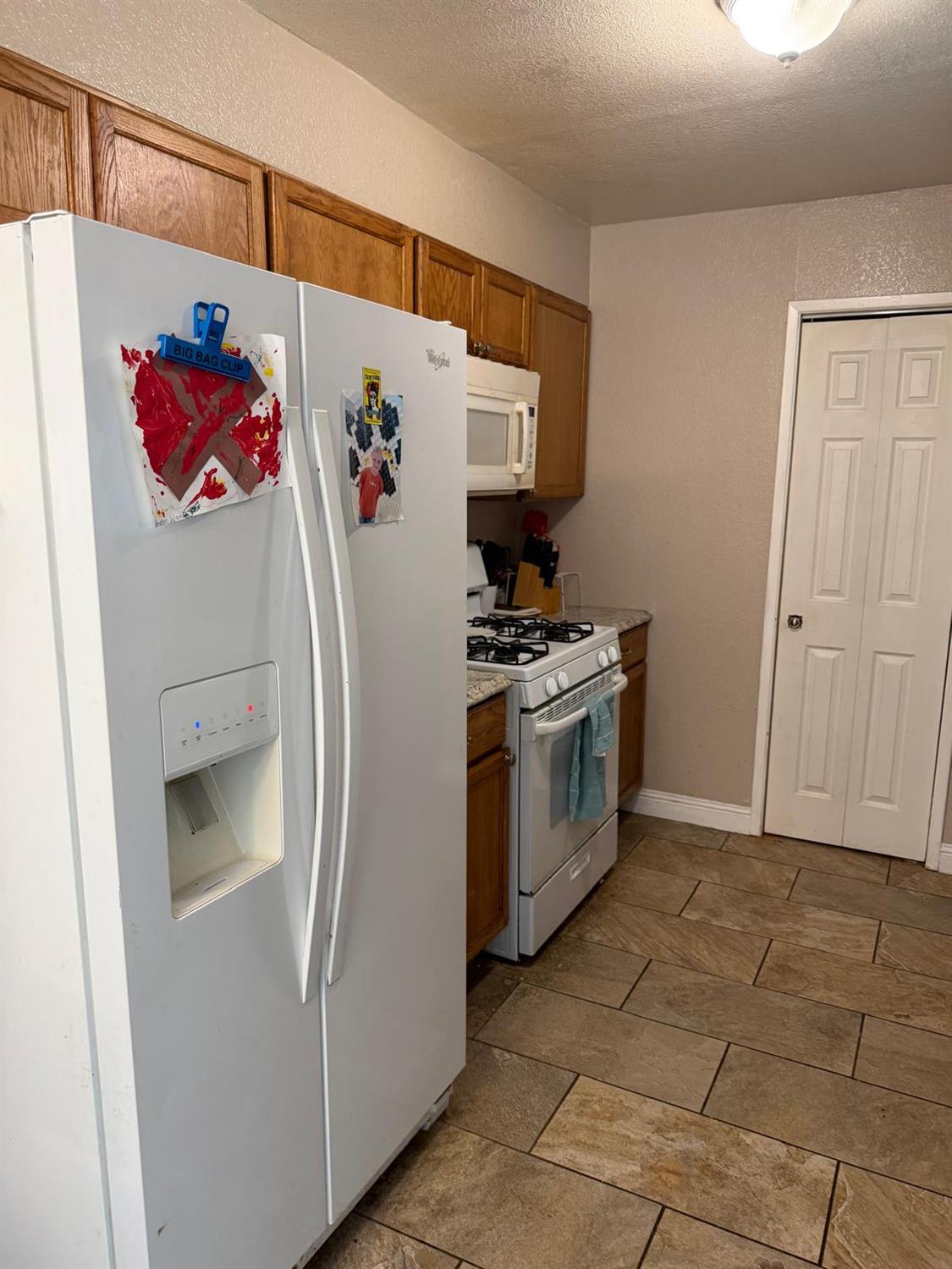 5109 Center Avenue Modesto, CA 95357 - Photo 3 of 45 a kitchen with a stove and a refrigerator