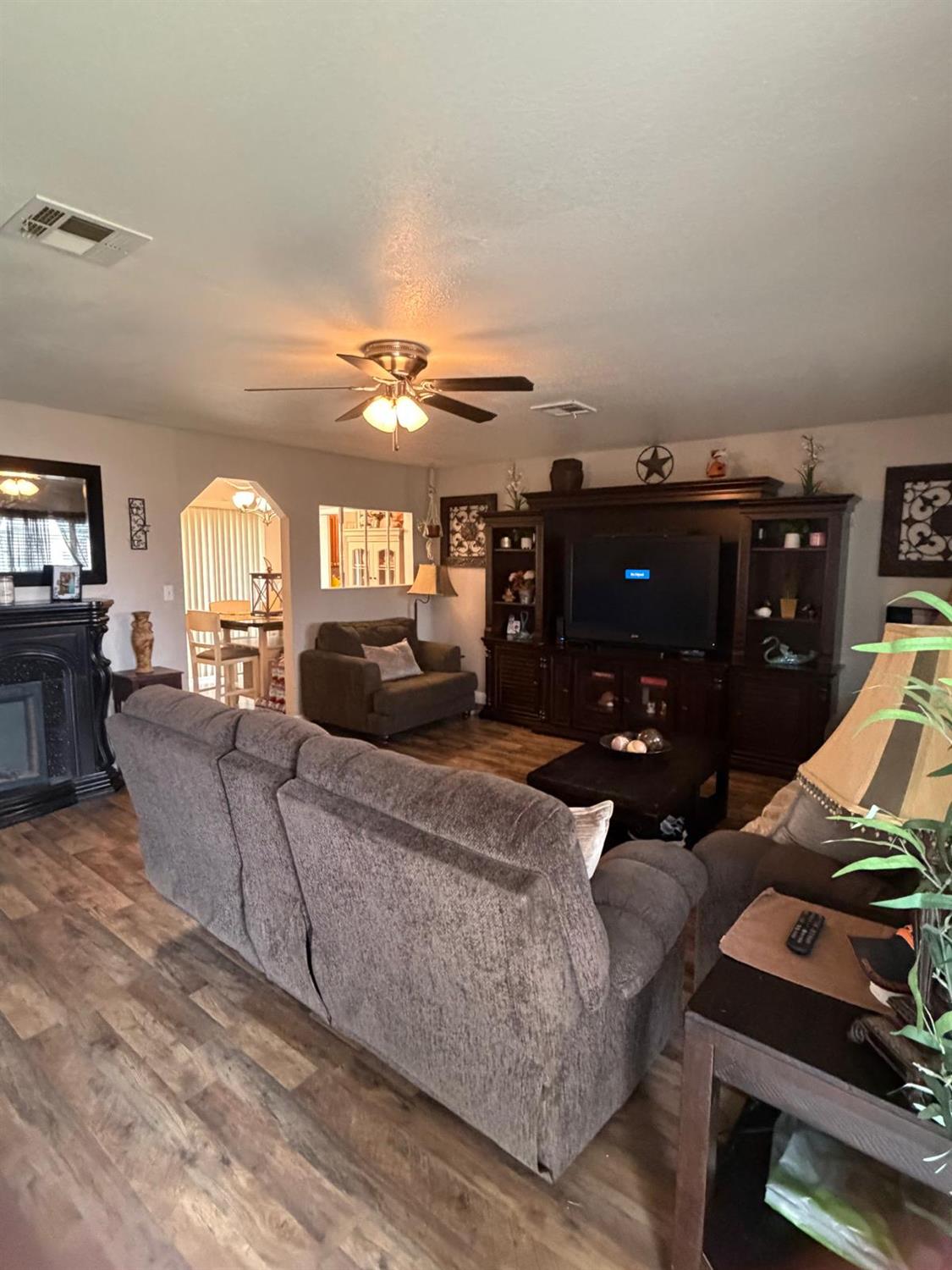 5109 Center Avenue Modesto, CA 95357 - Photo 32 of 45 a living room with furniture and a flat screen tv