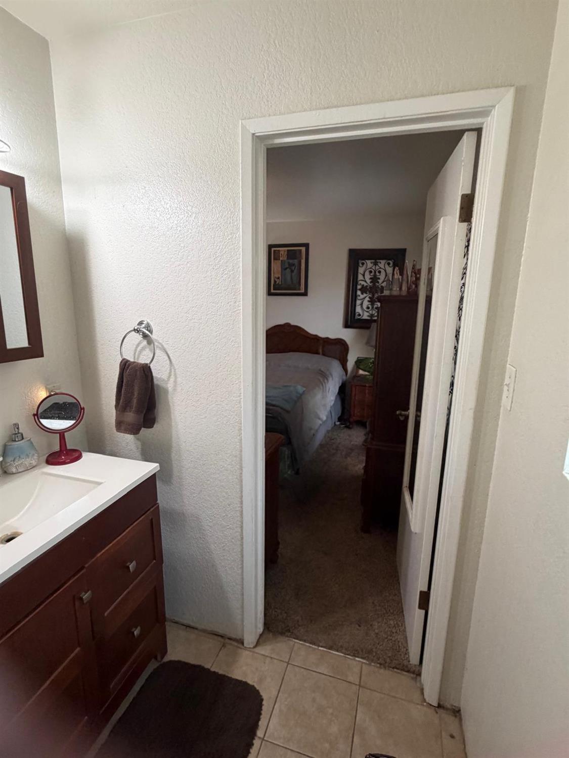 5109 Center Avenue Modesto, CA 95357 - Photo 34 of 45 a en suite bathroom with a sink and a mirror