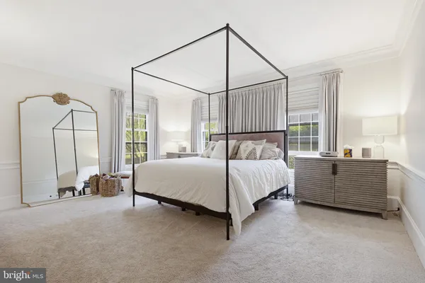 a bed room with a bed and a chair