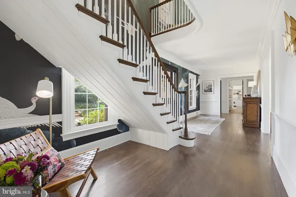 a view of entryway livingroom and hall with wooden floor