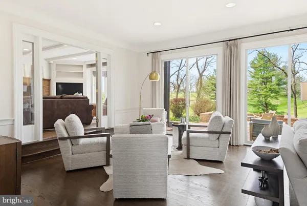 a living room with furniture and large windows