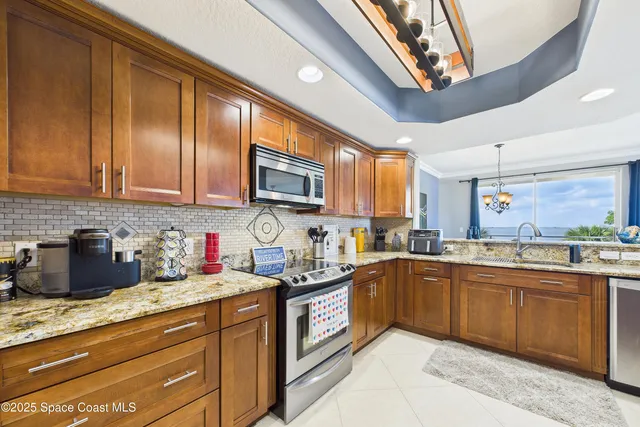 a view of a dining room with furniture large windows and wooden floor