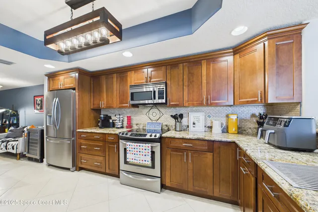 a bedroom with a bed a couch and a flat screen tv