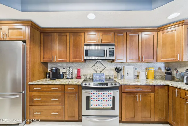 a bathroom with a granite countertop sink a mirror and a shower