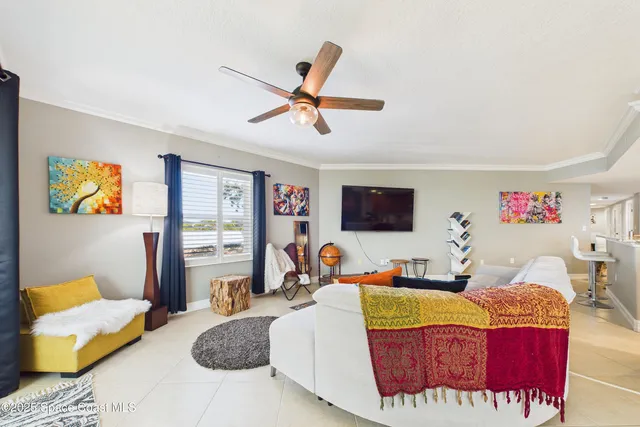 a bedroom with a bed and a flat tv screen on dresser