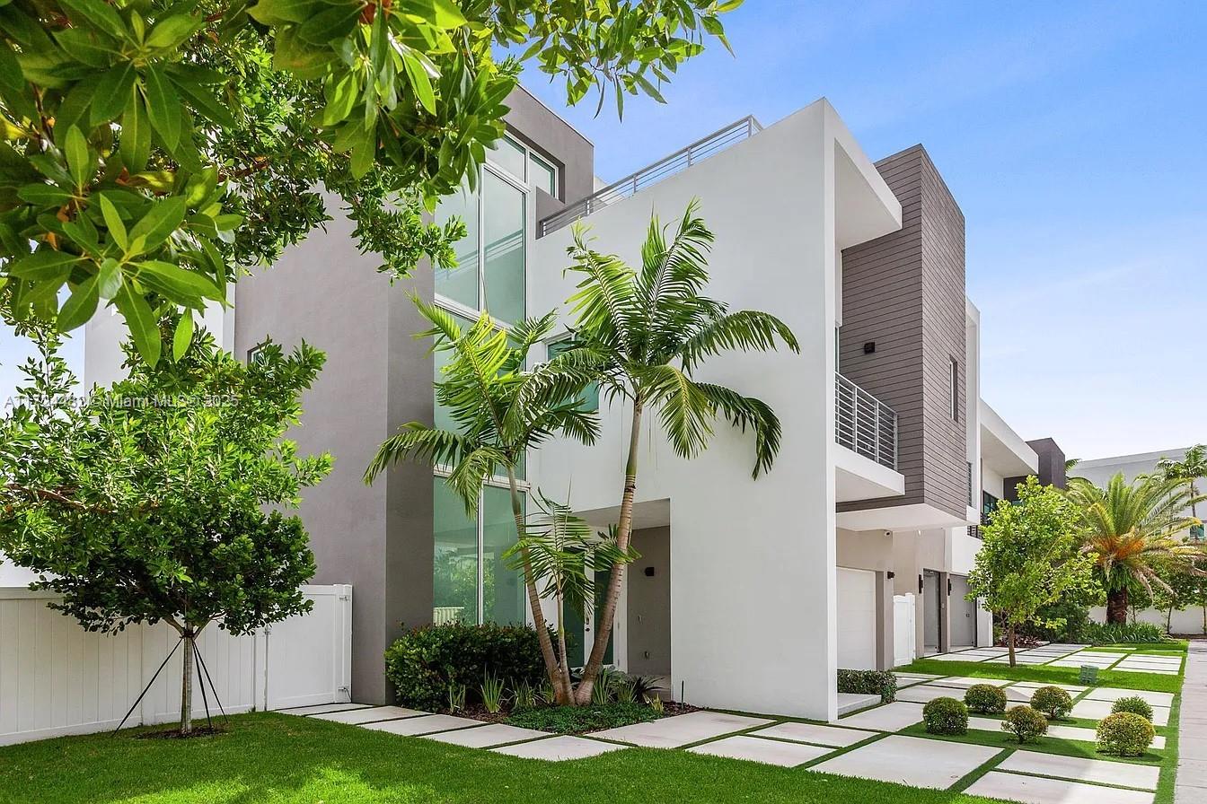 6821 Northwest 104th Court Doral, FL 33178 - Photo 1 of 31 a palm tree sitting in front of a white house with plants
