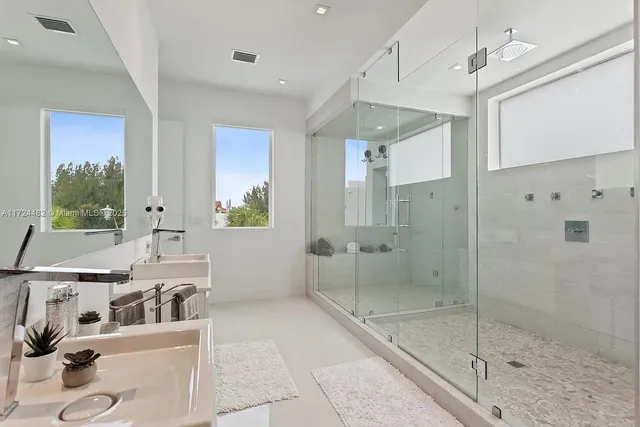 a bathroom with a tub sink and mirror