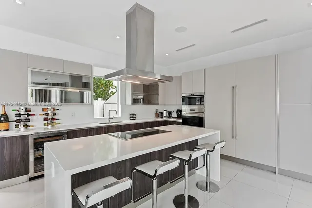 a kitchen with cabinets table and chairs