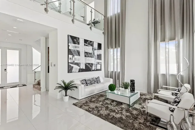 a living room with furniture windows and wooden floor