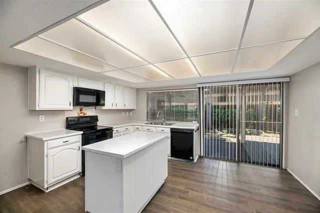 a kitchen with a stove a sink and a microwave