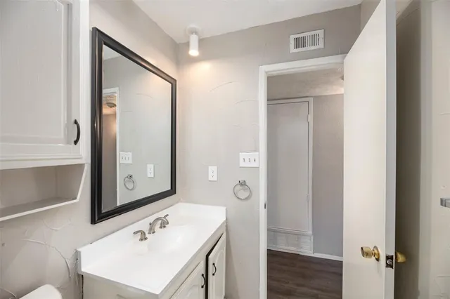 a bathroom with a sink a mirror and a shower