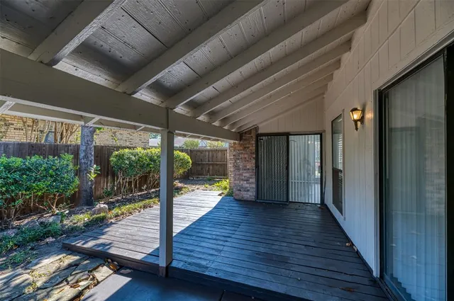 a view of a porch with wooden floor and stairs