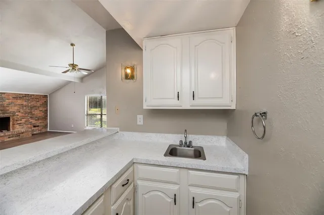 a kitchen with a sink cabinets and appliances