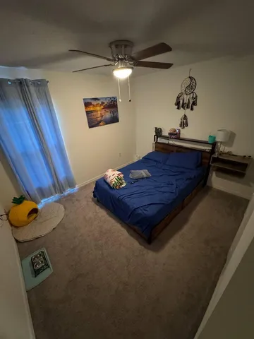 a bed sitting in a room next to a window