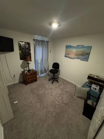 a room with furniture and a flat screen tv