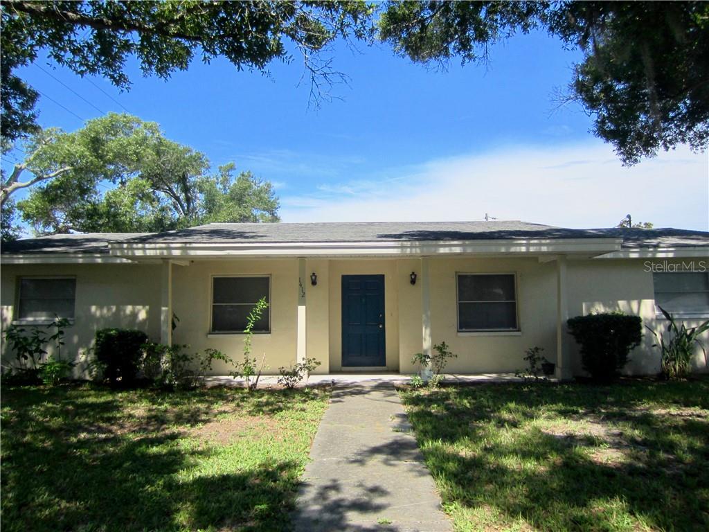 1412 Ruth Road Dunedin, FL 34698 - Photo 1 of 1 front view of a house with a yard