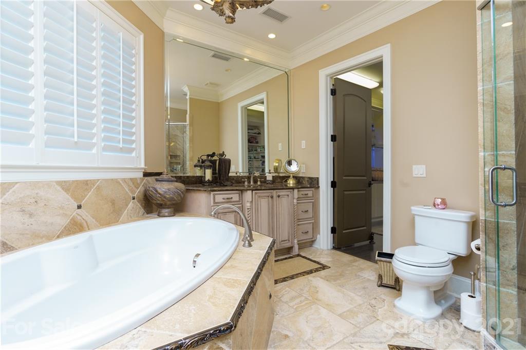 2823 Providence Road, Unit 235 Charlotte, NC 28211 - Photo 17 of 37 a bathroom with a bathtub and a toilet