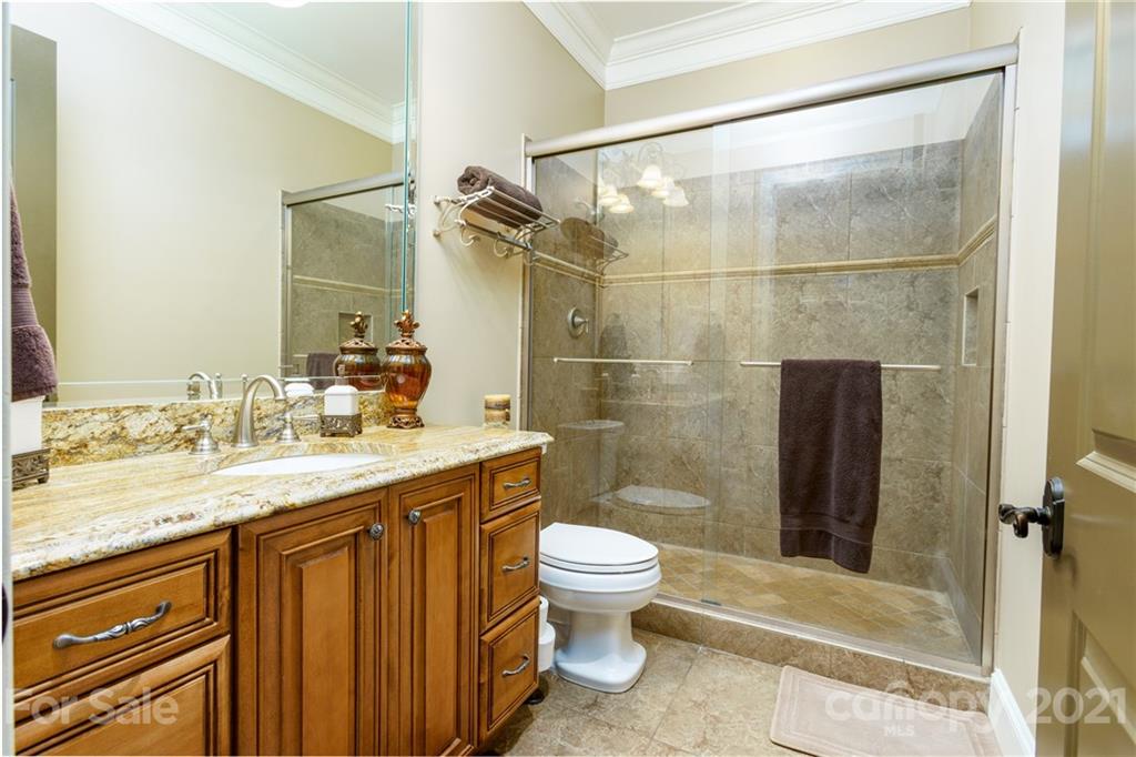 2823 Providence Road, Unit 235 Charlotte, NC 28211 - Photo 22 of 37 a bathroom with a granite countertop sink toilet and shower