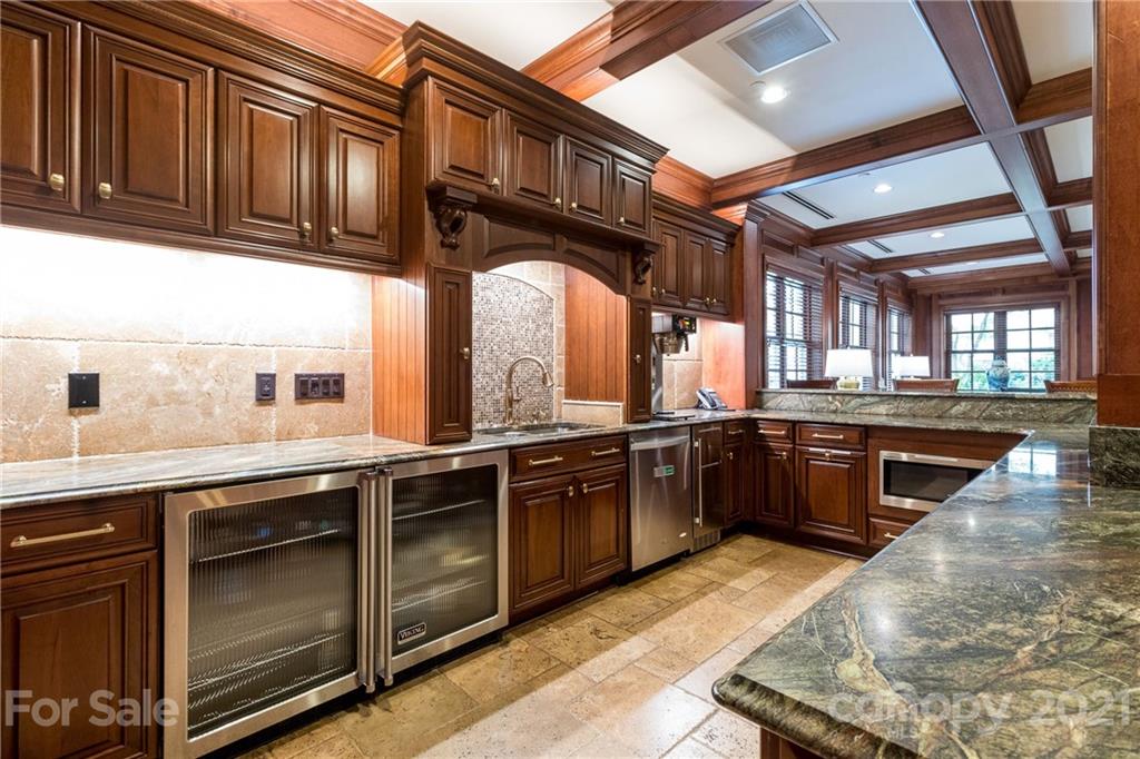2823 Providence Road, Unit 235 Charlotte, NC 28211 - Photo 27 of 37 a kitchen with stainless steel appliances granite countertop a sink and wooden cabinets