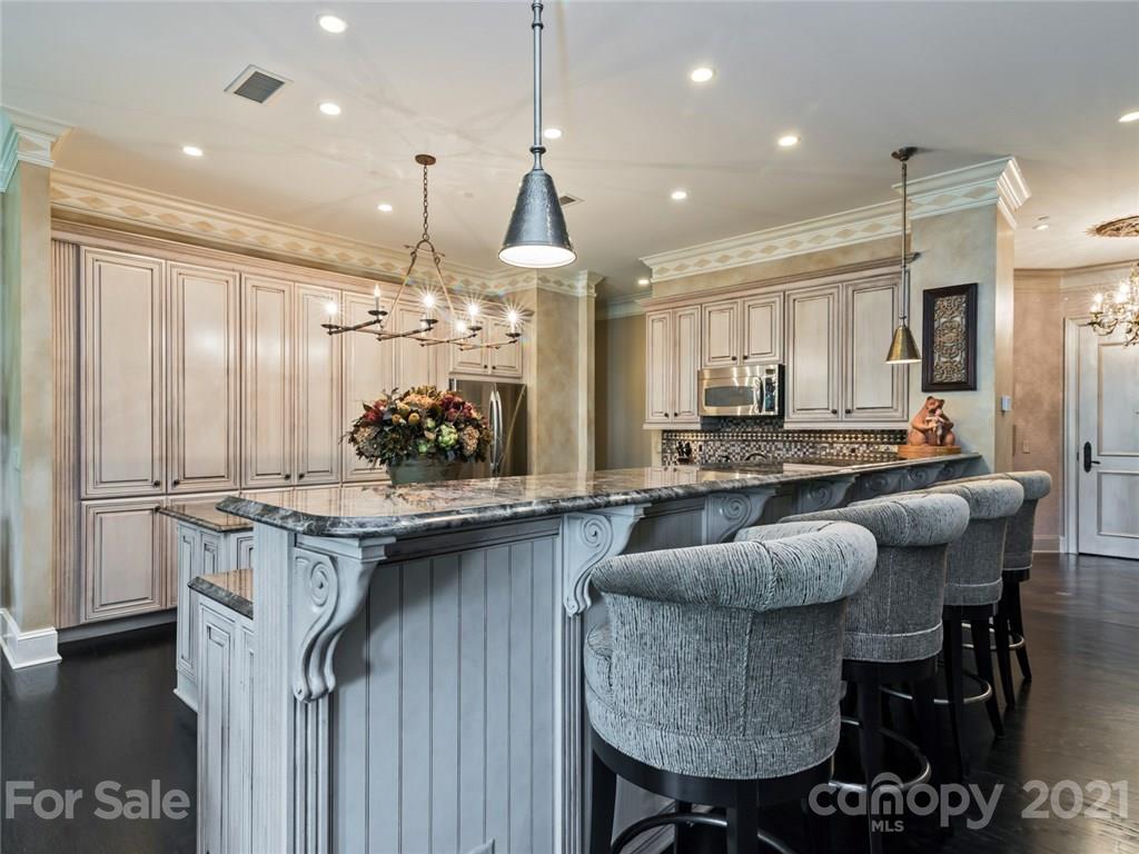 2823 Providence Road, Unit 235 Charlotte, NC 28211 - Photo 9 of 37 a kitchen with center island table and chairs