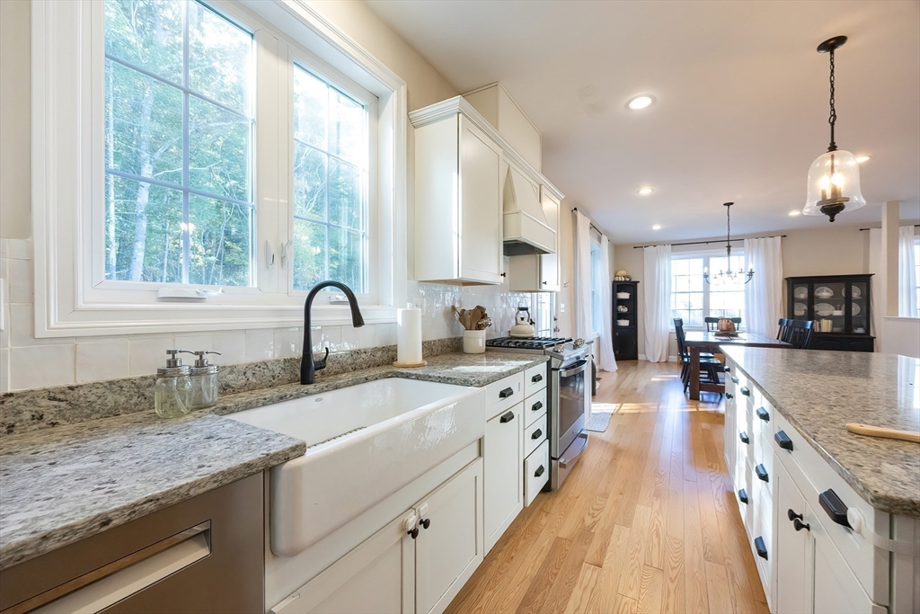 4 Sheppards Way Ipswich, MA 01938 - Photo 16 of 37 a large kitchen with stainless steel appliances granite countertop a stove a sink dishwasher and a white cabinets with wooden floor