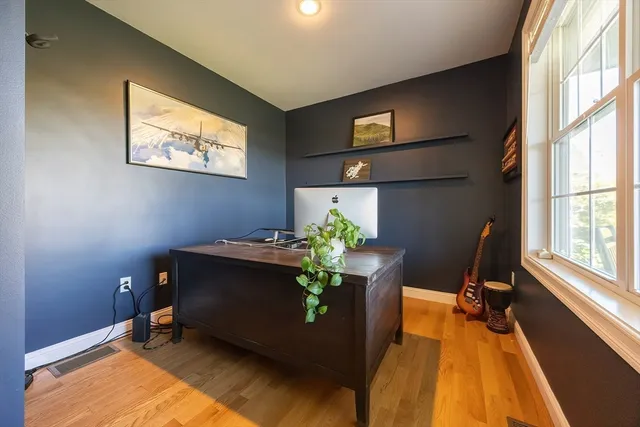 a view of a livingroom with wooden floor and a flat screen tv
