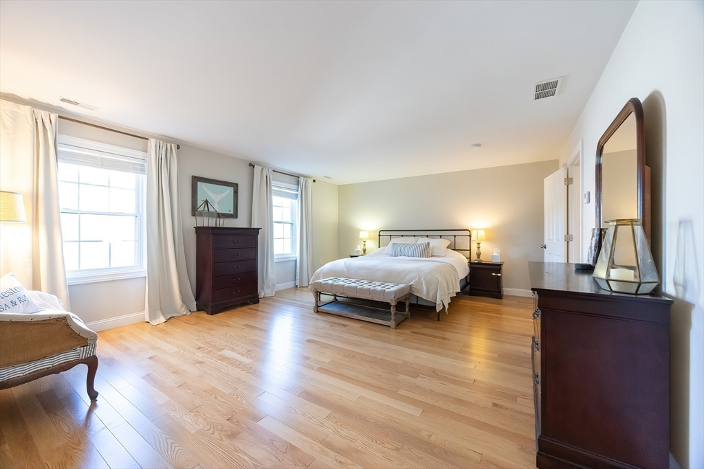 4 Sheppards Way Ipswich, MA 01938 - Photo 24 of 37 a bedroom with a bed and wooden floor