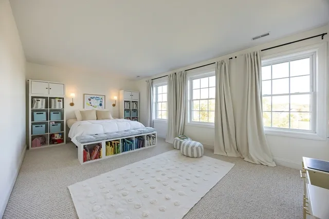 a bedroom with bed and window