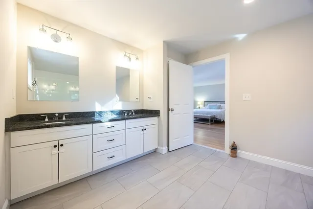 a bathroom with a toilet a sink and mirror