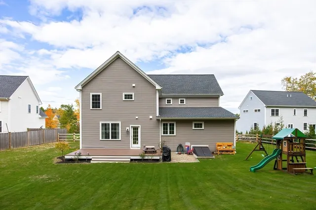 a view of a house with backyard sitting area and garden