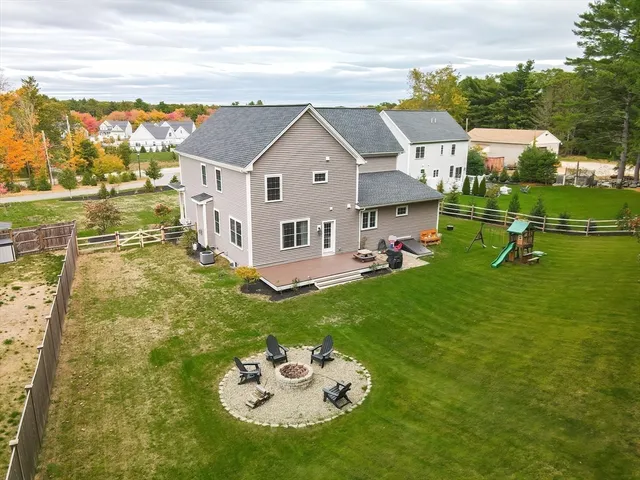 an aerial view of a house with a yard