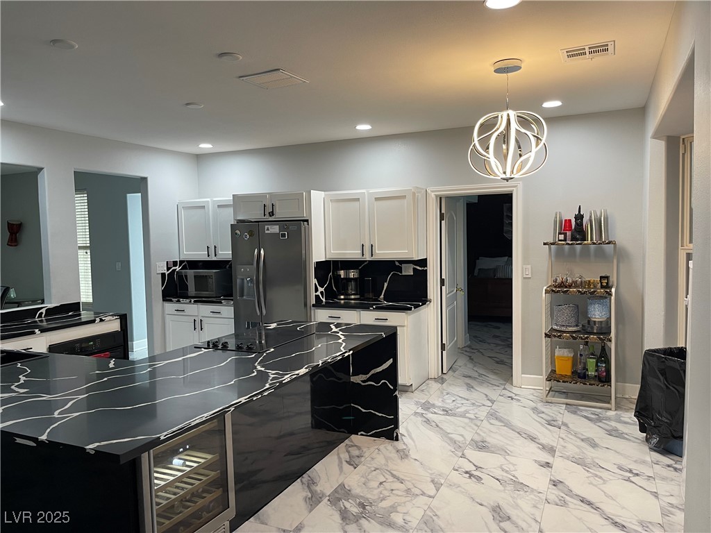 6480 West Oquendo Road Las Vegas, NV 89118 - Photo 11 of 51 Kitchen with wine cooler, white cabinets, decorative light fixtures, stainless steel fridge with ice dispenser, and a chandelier