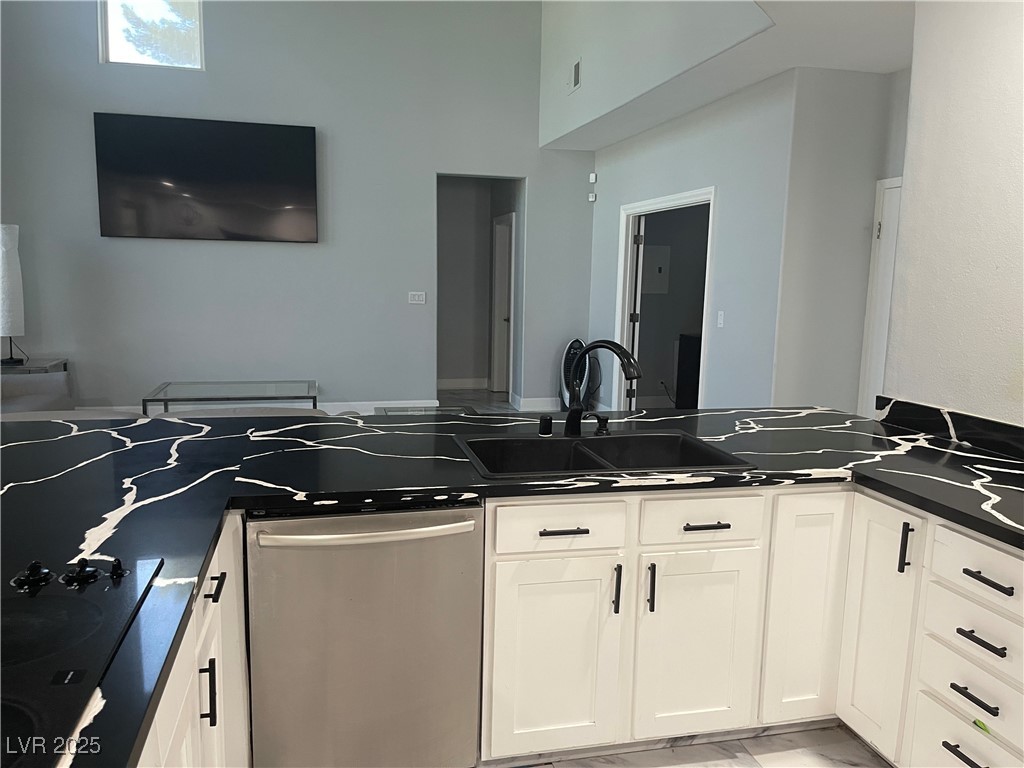 6480 West Oquendo Road Las Vegas, NV 89118 - Photo 13 of 51 Kitchen featuring stainless steel dishwasher, white cabinetry, black electric cooktop, and a peninsula