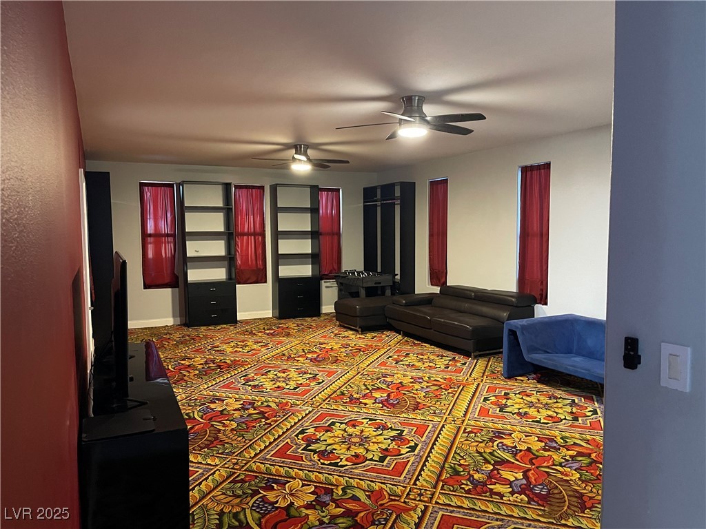 6480 West Oquendo Road Las Vegas, NV 89118 - Photo 19 of 51 Carpeted home theater with ceiling fan and baseboards