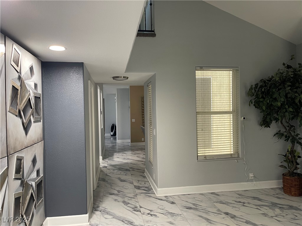 6480 West Oquendo Road Las Vegas, NV 89118 - Photo 21 of 51 Hall featuring light marble finish flooring and lofted ceiling