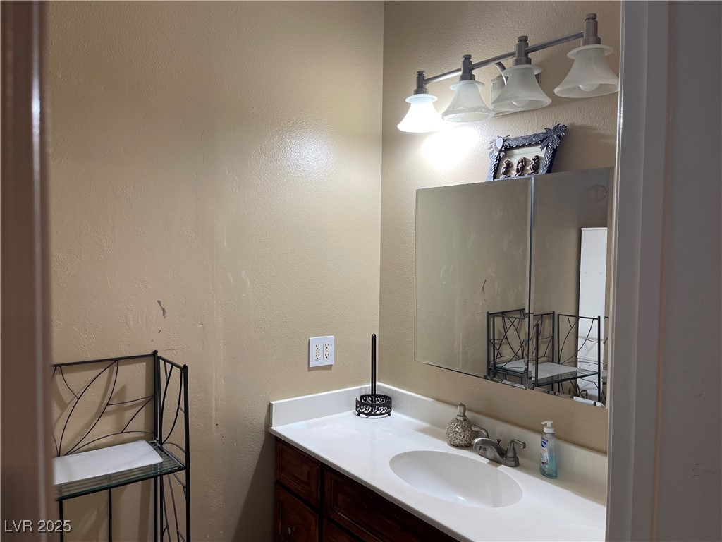 6480 West Oquendo Road Las Vegas, NV 89118 - Photo 34 of 51 Bathroom featuring a textured wall and vanity