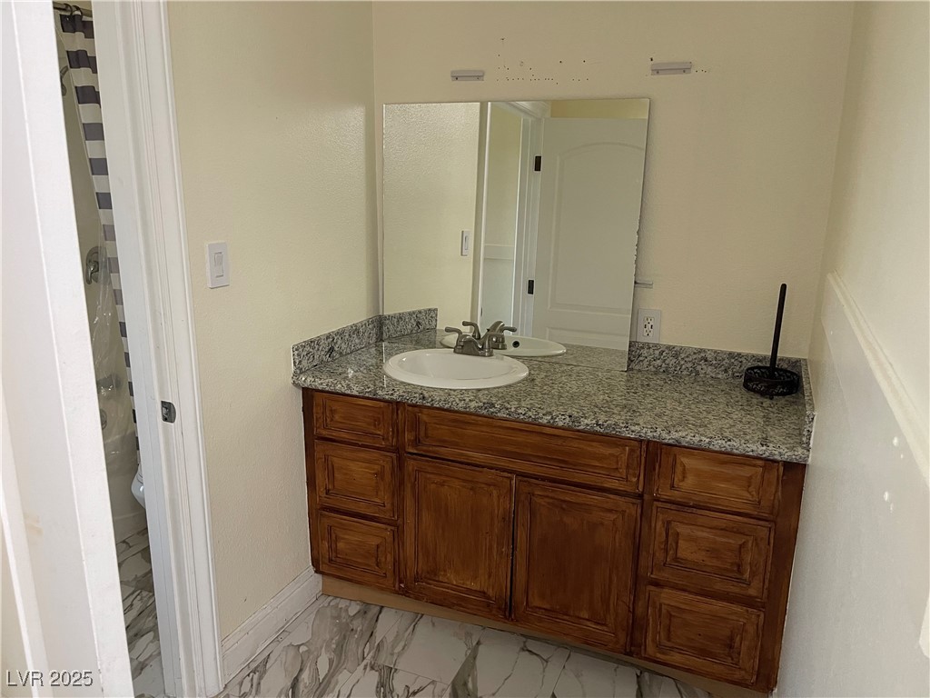 6480 West Oquendo Road Las Vegas, NV 89118 - Photo 36 of 51 Bathroom with vanity, light marble finish floors, and a shower with curtain