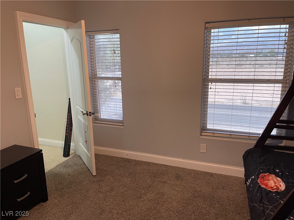 6480 West Oquendo Road Las Vegas, NV 89118 - Photo 37 of 51 Bedroom featuring carpet and baseboardsand closet