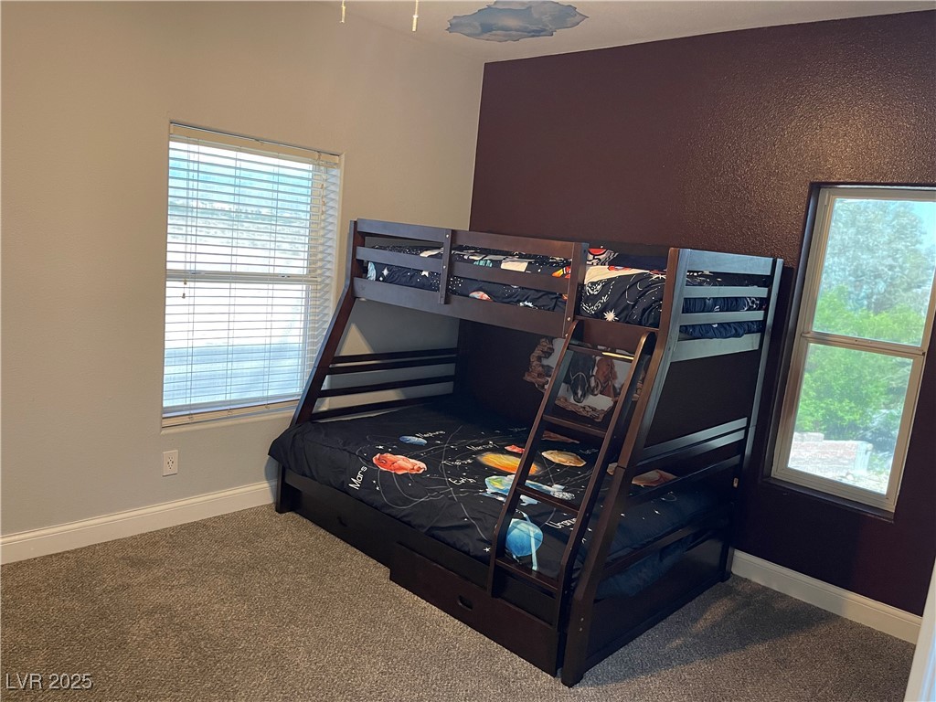 6480 West Oquendo Road Las Vegas, NV 89118 - Photo 38 of 51 Bedroom featuring baseboards and dark
carpet