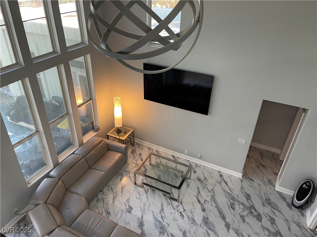 6480 West Oquendo Road Las Vegas, NV 89118 - Photo 4 of 51 Living room featuring marble finish flooring and baseboards