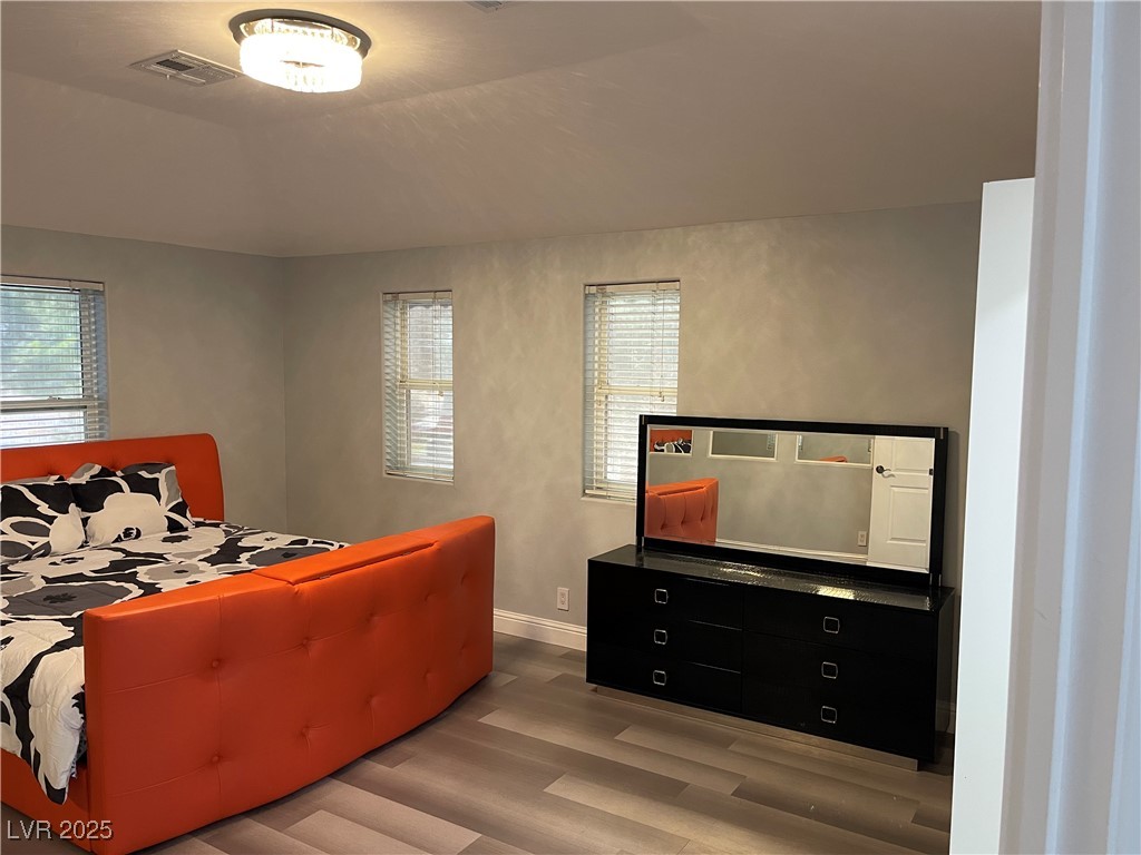 6480 West Oquendo Road Las Vegas, NV 89118 - Photo 40 of 51 Bedroom with wood finished floors and lofted ceiling