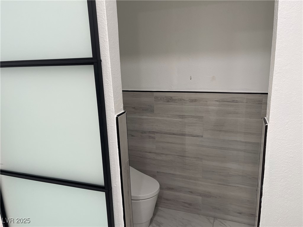 6480 West Oquendo Road Las Vegas, NV 89118 - Photo 42 of 51 Bathroom with toilet and light marble finish flooring