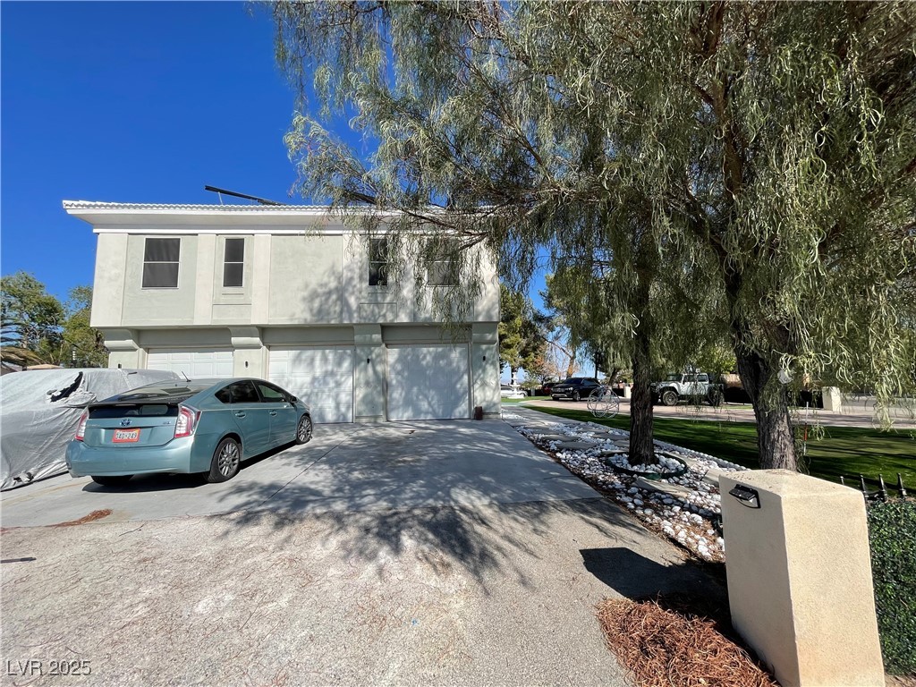 6480 West Oquendo Road Las Vegas, NV 89118 - Photo 49 of 51 View of front facade with driveway, an attached garage, and stucco siding