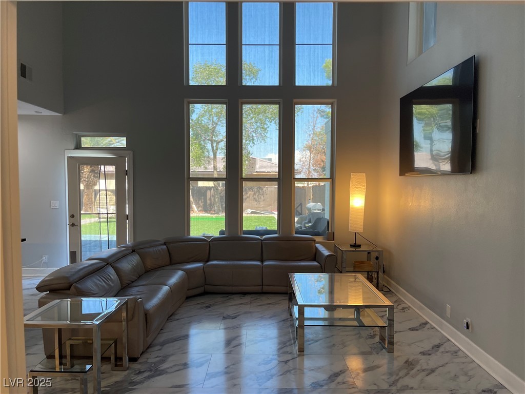6480 West Oquendo Road Las Vegas, NV 89118 - Photo 7 of 51 Living room with marble finish flooring and a towering ceiling
