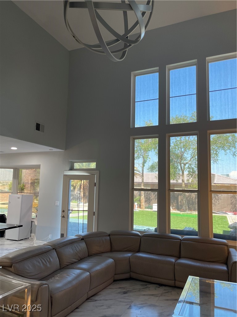 6480 West Oquendo Road Las Vegas, NV 89118 - Photo 9 of 51 Living area featuring a towering ceiling