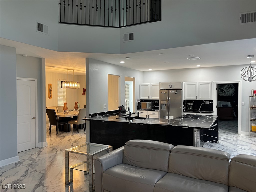 6480 West Oquendo Road Las Vegas, NV 89118 - Photo 10 of 51 Living room with light marble finish floors, a chandelier, and recessed lighting