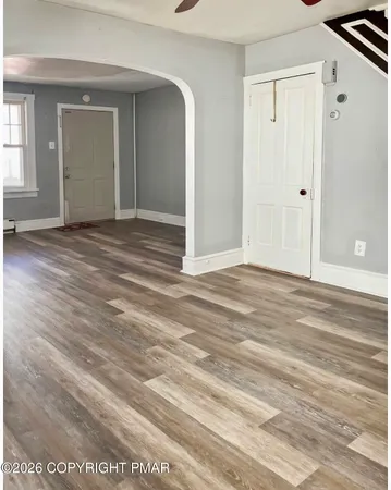 a view of a room with wooden floor