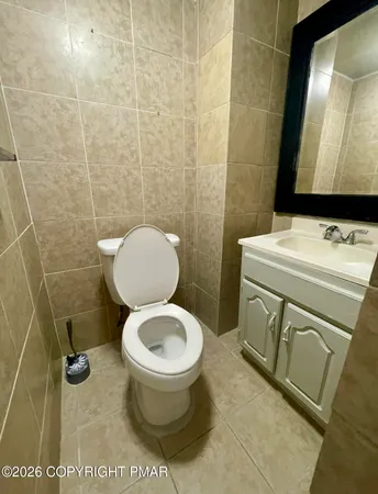 a bathroom with a toilet and a mirror