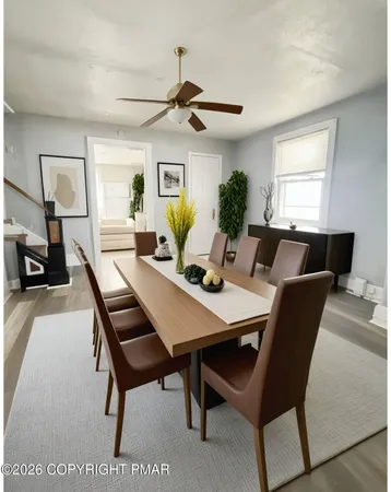 a view of a dining room with a table and chairs